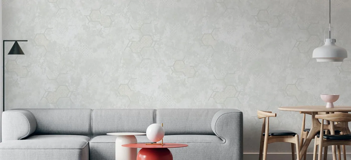 Minimal grey room with a subtle concrete-texture wallpaper and industrial pendant lights
